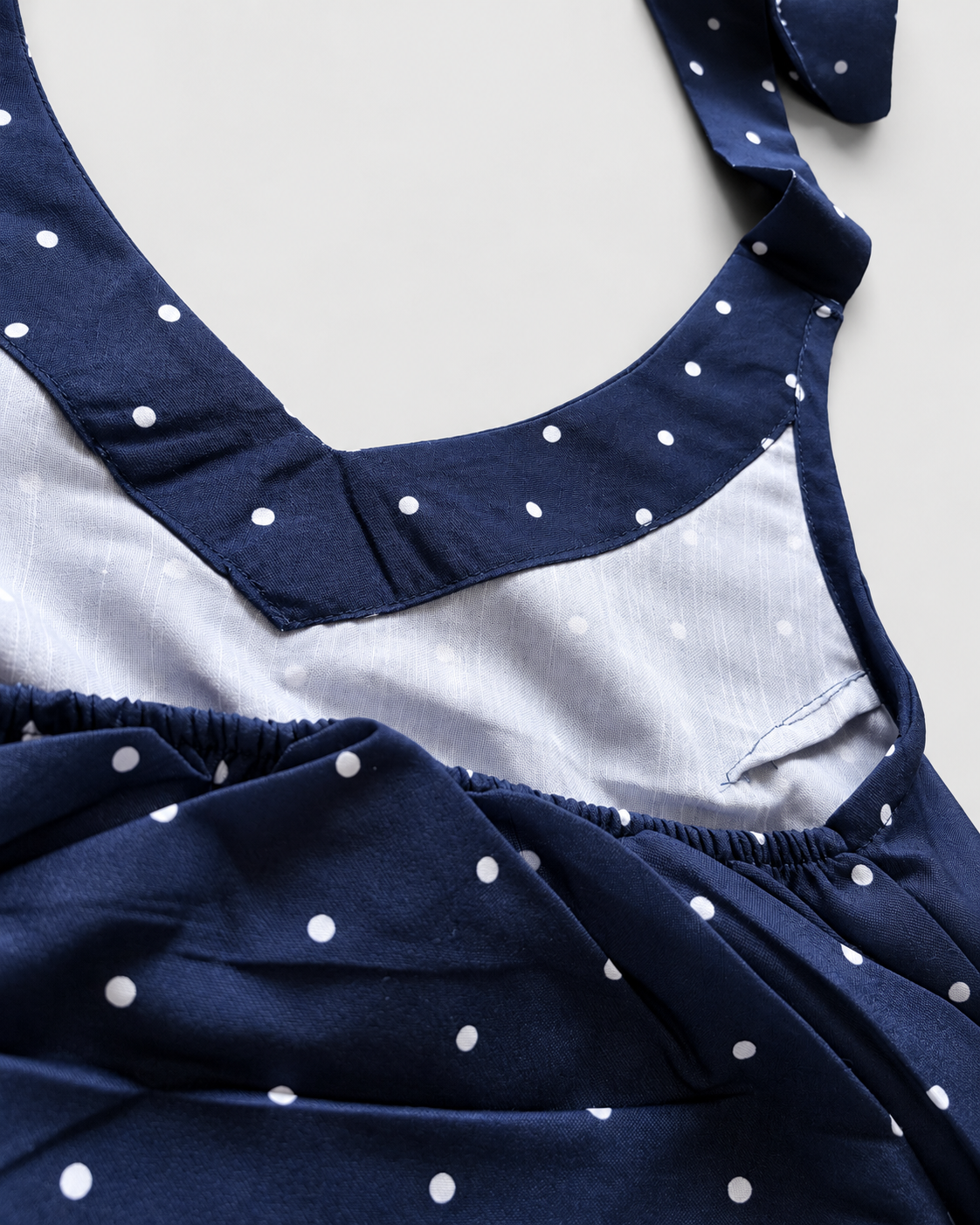 Navy blue white polka-dot halter crop top detail