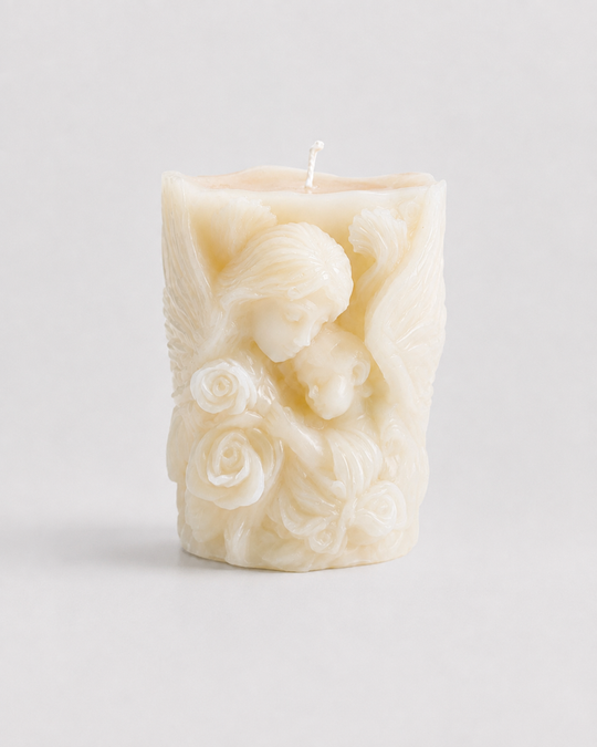 Grey Exim Moon Petal French Vanilla candle with a winged figure holding a child among sculpted roses, front view